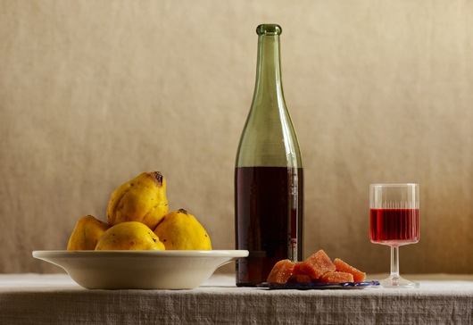 Still life with wine and quinces