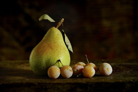 Still life with a pear and prunes