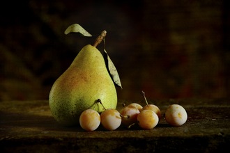 Still life with a pear and prunes
